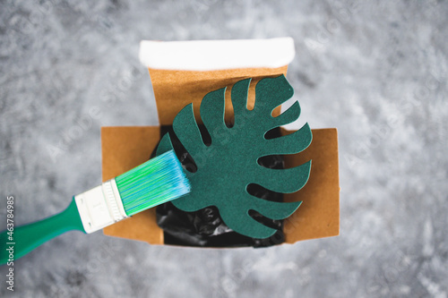 Obraz na plátně greenwashing and companies pretending to be sustainable, paper leaf with green b
