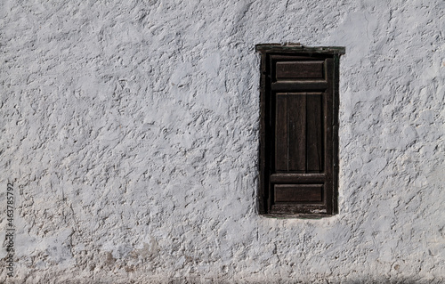 Closeup of wooden window on white wall