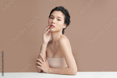 Beautiful young asian woman with clean fresh skin on beige background, Face care, Facial treatment, Cosmetology, beauty and spa, Asian women portrait. photo
