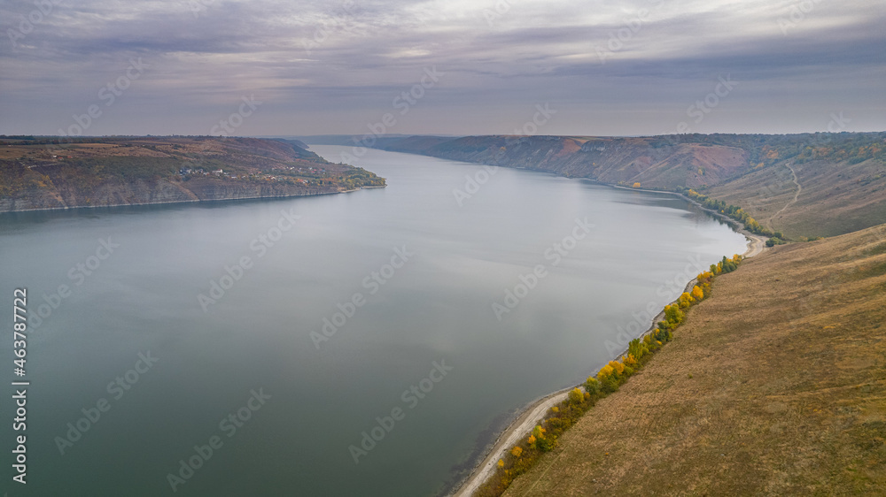 Autumn view on panorama of the Dniester River. landscape with canyon, forest and a river in front. beautiful nature scenery with cloudy sky and calm majestic river.