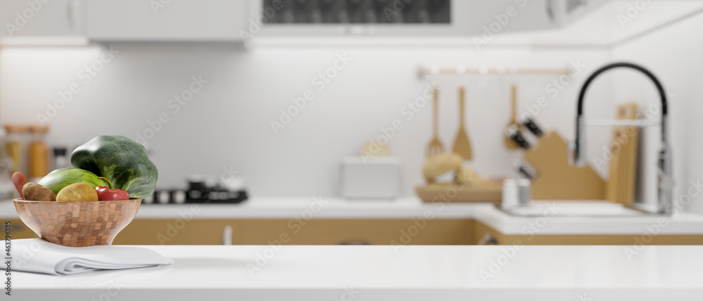 White kitchen countertop with vegetables bowl, napkin and space for montage on blurred modern bright kitchen - obrazy, fototapety, plakaty 