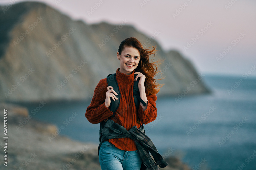 woman travels with a backpack on her back mountains landscape walk