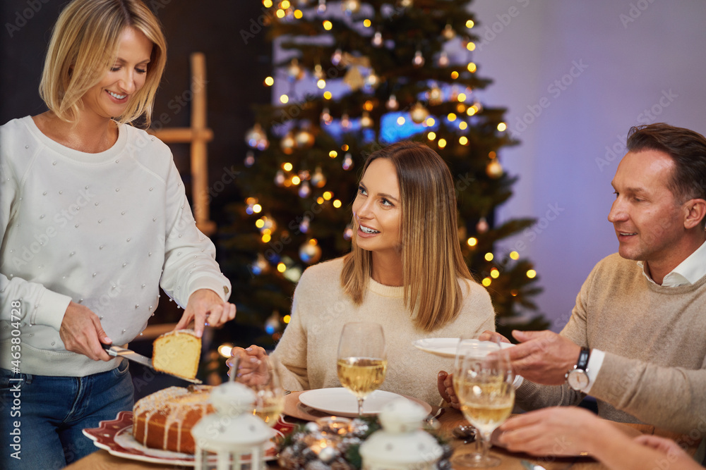 Friends celebrating christmas party holding wine Friends celebrating christmas party holding wine