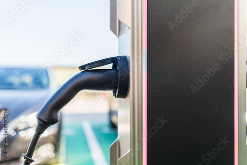 Charging an electric car with the power cable supply plugged in.Charging modern electric car on the street which are the future of the automobile.Copy space.