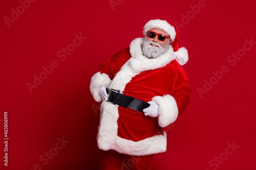 Portrait of attractive cheerful Santa posing big belly newyear festal day time look isolated over bright red color background