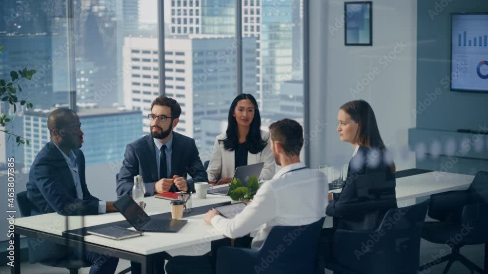 Modern Multi-Ethnic Office Conference Room Meeting: Diverse Team of Managers, Executives Talk, Brainstorm, Use Computers. Businesspeople Discuss Investment Strategy in e-Commerce Startup. Wide Shot