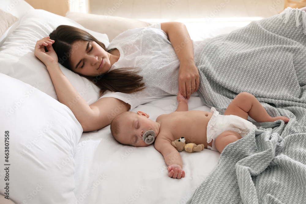 Mother with her cute baby sleeping in bed Mother with her cute baby sleeping in bed