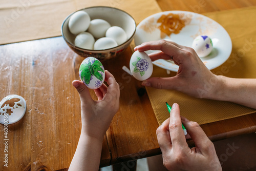 Wallpaper Mural family traditions, mother and daughter at the table paint eggs for Easter Torontodigital.ca