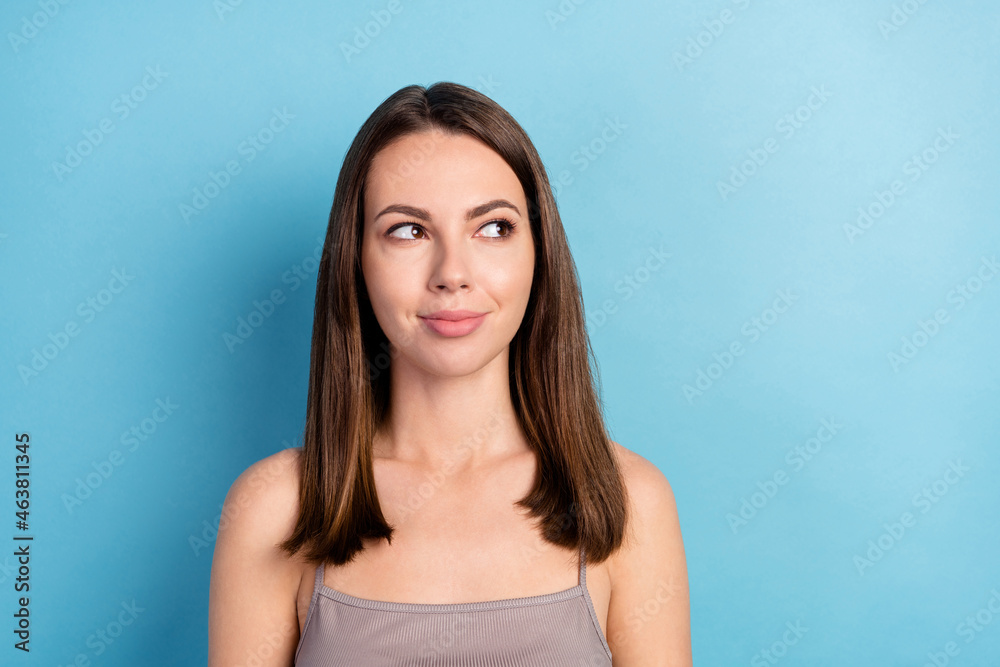 Photo portrait pretty woman smiling looking blank space isolated pastel blue color background Photo portrait pretty woman smiling looking blank space isolated pastel blue color background