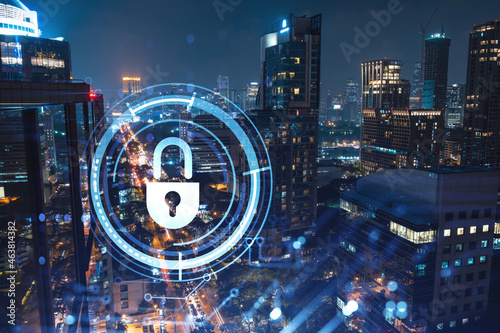 Glowing Padlock hologram, night panoramic city view of Bangkok, Southeast Asia. The concept of cyber security to protect companies. Double exposure.