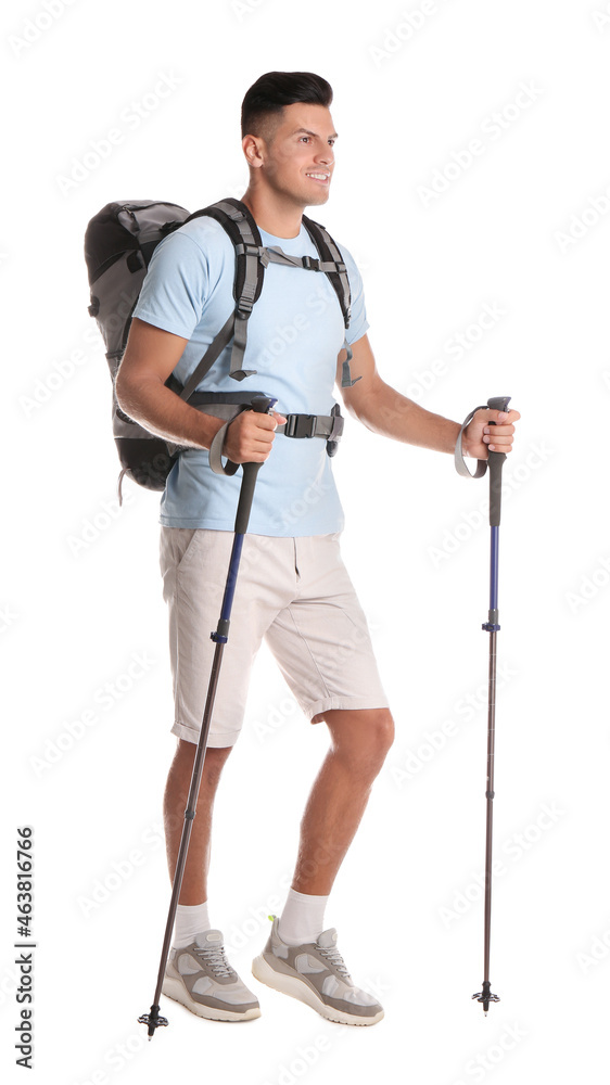 Male hiker with backpack and trekking poles on white background