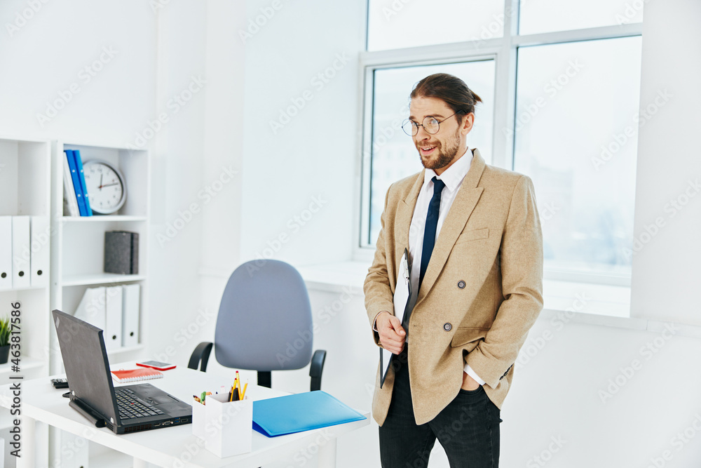man in beige jacket holding a phone telephone office executive man in beige jacket holding a phone telephone office executive