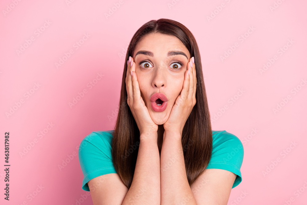 Photo of young woman amazed shocked surprised omg wow hands touch cheeks news isolated over pink color background Photo of young woman amazed shocked surprised omg wow hands touch cheeks news isolated over pink color background