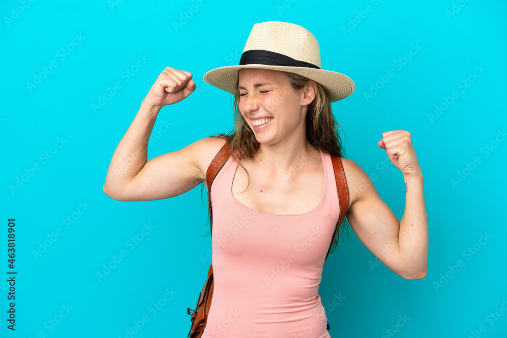 Young caucasian woman in summer holidays isolated on blue background celebrating a victory Young caucasian woman in summer holidays isolated on blue background celebrating a victory