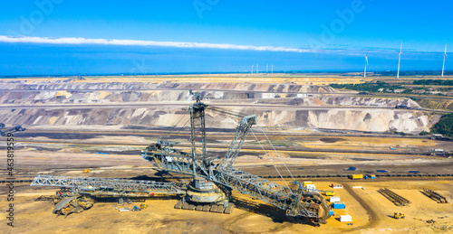 A huge bucket-wheel excavator digging coal on the open-pit mine. Garzweiler open cast mine, Jackerath.
Aerialview of the largest lignite mining factory in Europe located in North Rhine-Westphalia. photo