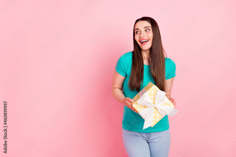 Photo of young cheerful woman happy positive smile get gift box celebration isolated over pastel color background Photo of young cheerful woman happy positive smile get gift box celebration isolated over pastel color background