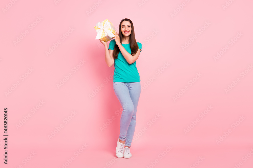 Full length photo of young woman happy positive smile hold present box guest isolated over pastel color background Full length photo of young woman happy positive smile hold present box guest isolated over pastel color background