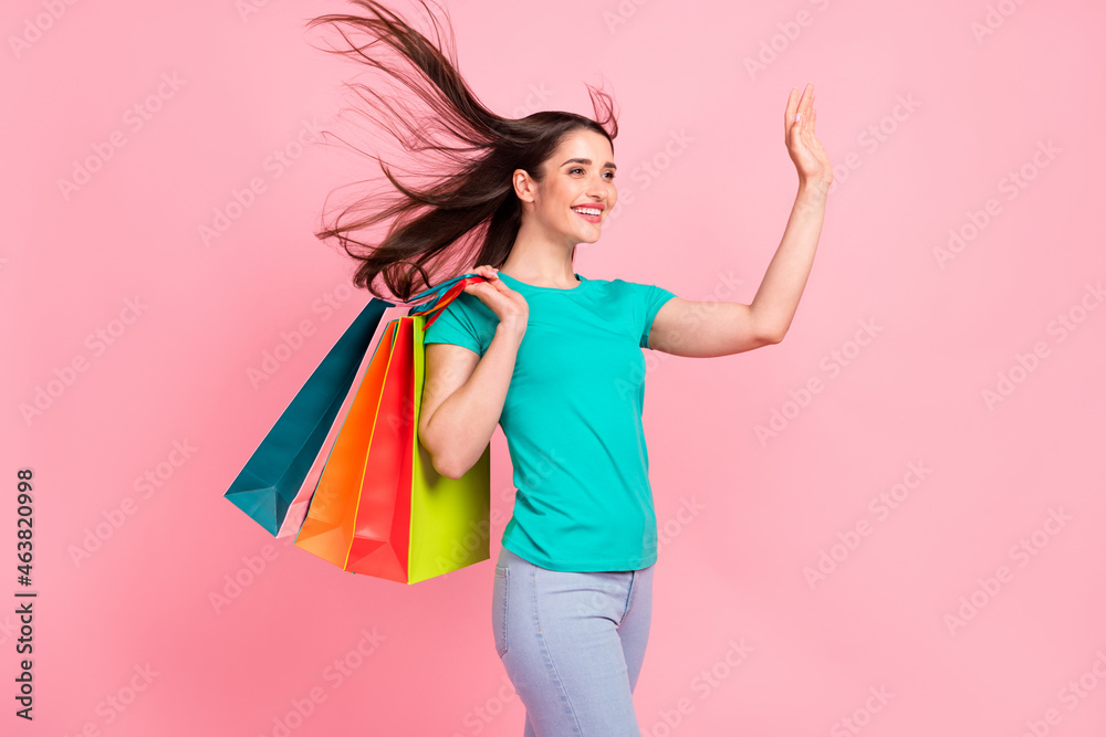 Profile side photo of young woman happy positive smile waving hand hello shopping buy isolated over pastel color background