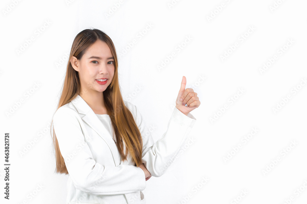 Young Asian professional woman with bronze long hair wearing a white suit pretty smiling and thumbs up is present product on white background. Young Asian professional woman with bronze long hair wearing a white suit pretty smiling and thumbs up is present product on white background.
