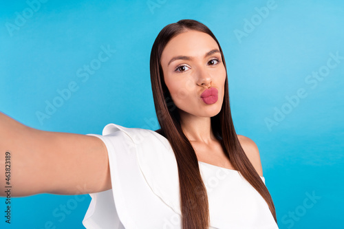 Photo of affectionate blogger lady blow air kiss shoot selfie wear white blouse isolated blue color background