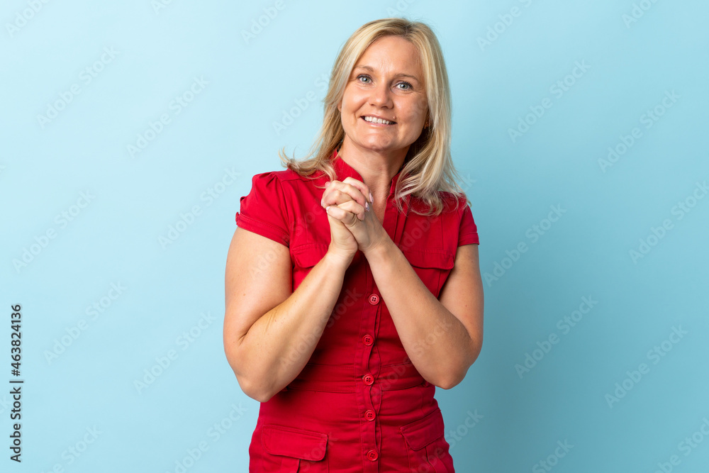 Middle age woman isolated on blue background laughing Middle age woman isolated on blue background laughing