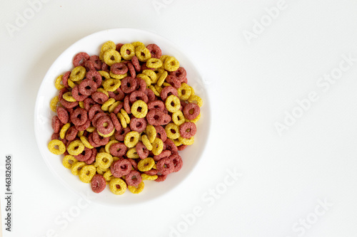bowl of whole grain cereal rings breakfast isolated on white background