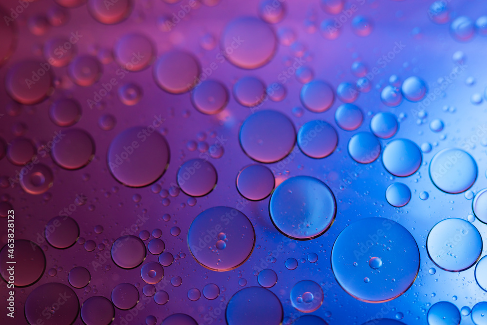 Water in oil in abstract style on blue background. blue liquid splash. Golden yellow bubble oil abstract background.