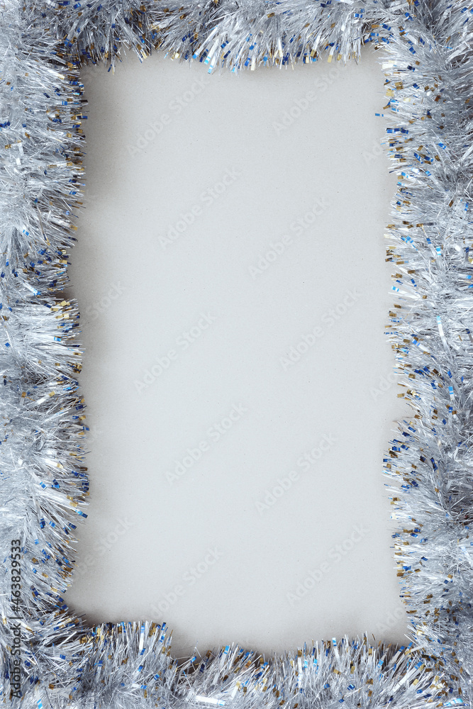 Silver Christmas tinsel frames an empty light sheet. Christmas mockup