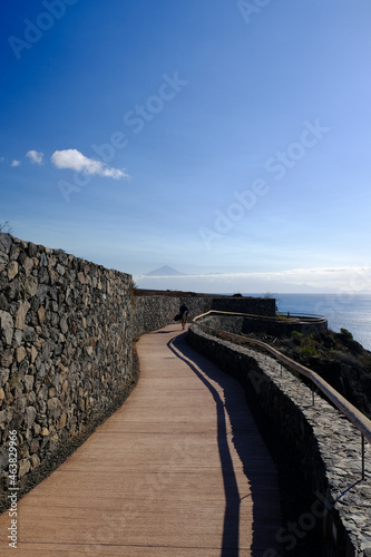 A coast promenade in  Playa Santiago  town overlooking the Atlantic Ocean and  El Teide  peak. La Gomera island  Canary Islands  Spain 