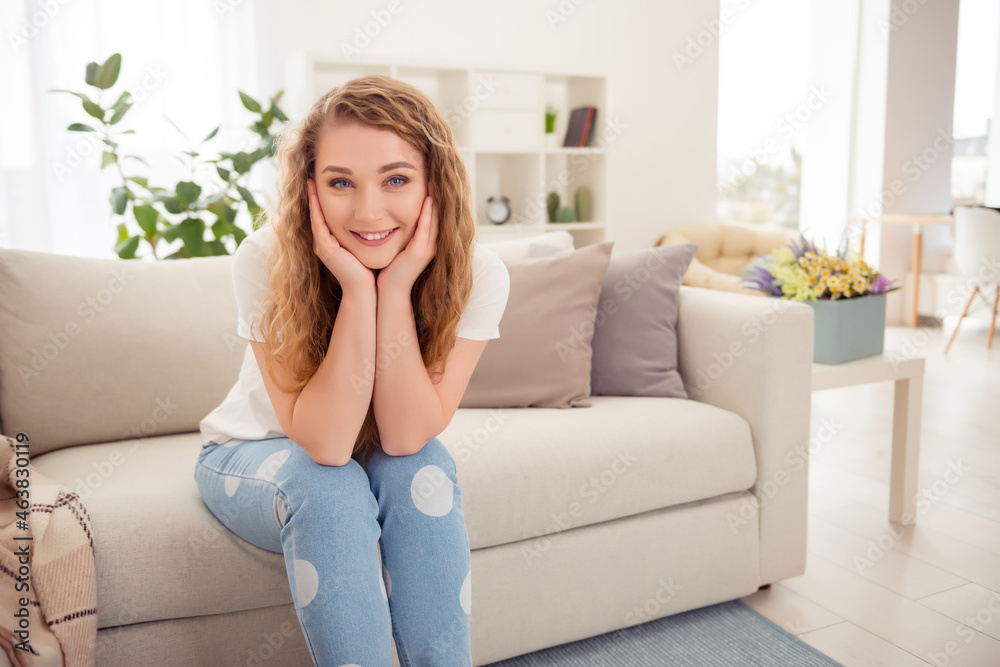Photo of nice adorable lovely sweet redhead woman smile sit couch hands cheeks indoors home