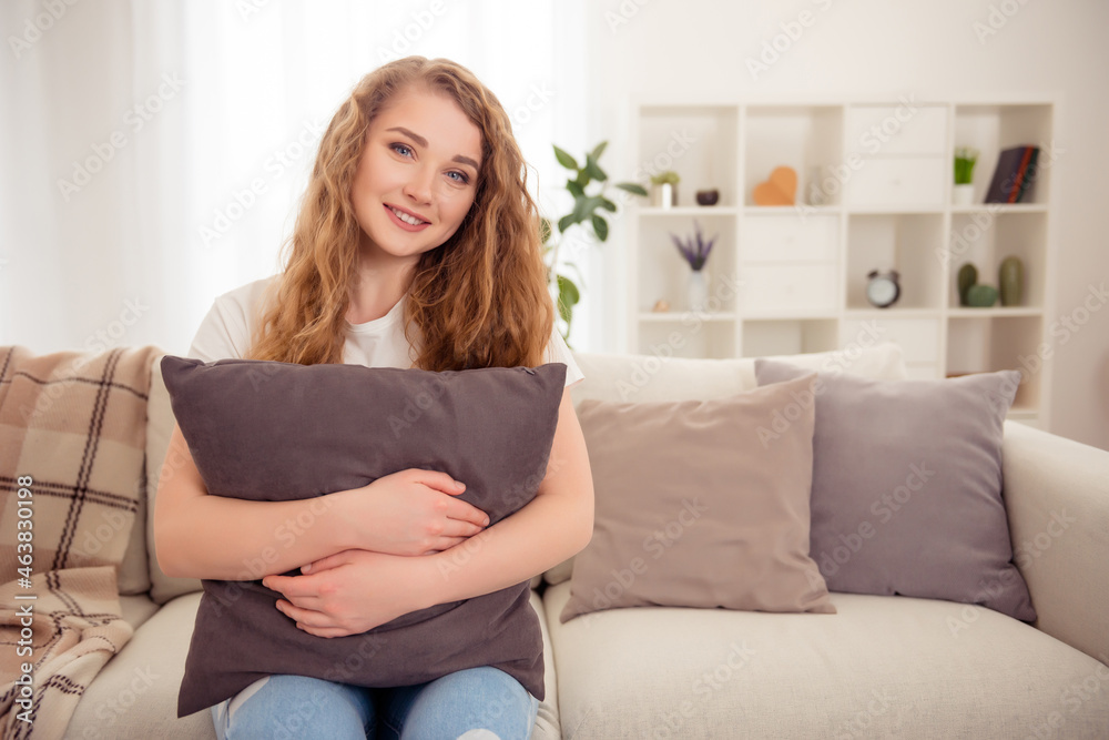 Charming pretty redhead lady sit sofa enjoy rest embrace soft pillow home indoors