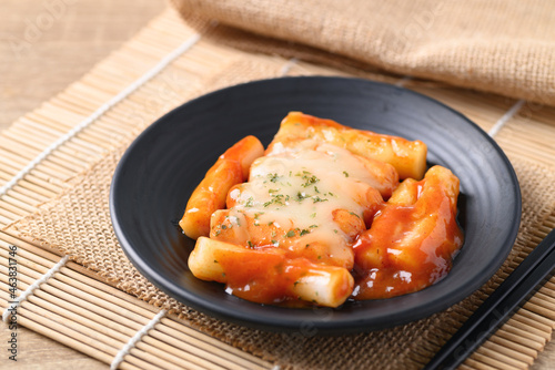 Korean food, Tteokbokki (sliced rice cakes) or tokpokki and sausage with cheese in spicy sauce photo