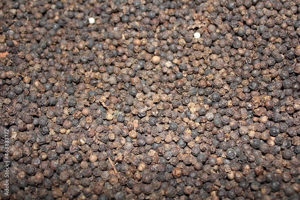 Closeup background dried black peppercorns