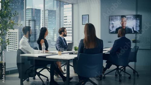 Video Conference Call Office Meeting Room: Black Female Executive Talks with Group of Multi-Ethnic Digital Entrepreneurs, Managers, Investors. Businesspeople Discuss e-Commerce Investment. Wide Shot photo