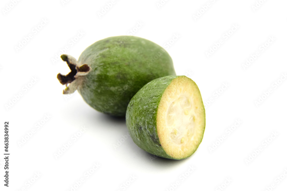 Feijoa fruit or whole and half pineapple guava isolated on white Feijoa fruit or whole and half pineapple guava isolated on white