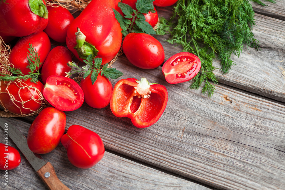 Fresh vegetables, sweet tomatoes and bell peppers on wooden background. Organic food. Top view Fresh vegetables, sweet tomatoes and bell peppers on wooden background. Organic food. Top view