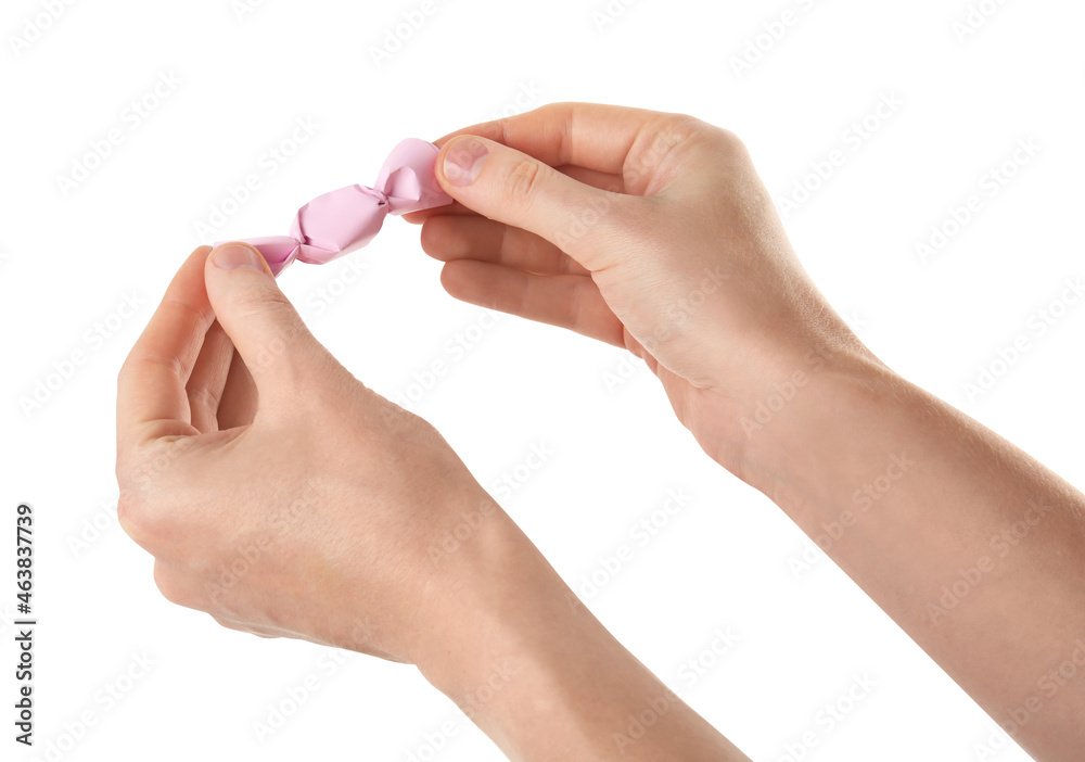 Woman unwrapping delicious candy isolated on white, closeup Woman unwrapping delicious candy isolated on white, closeup