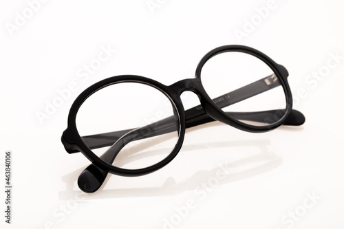 Eyeglasses And Its Reflection Against Light Background