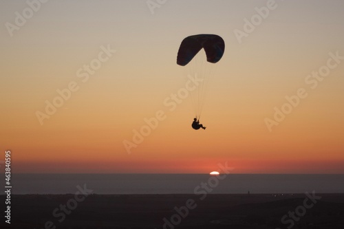 paraglider silhouette at sunset