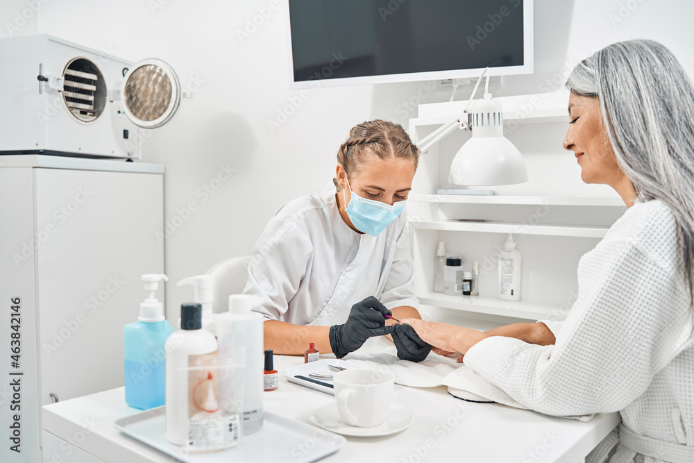 Fototapeta premium Positive delighted female person working in beauty salon