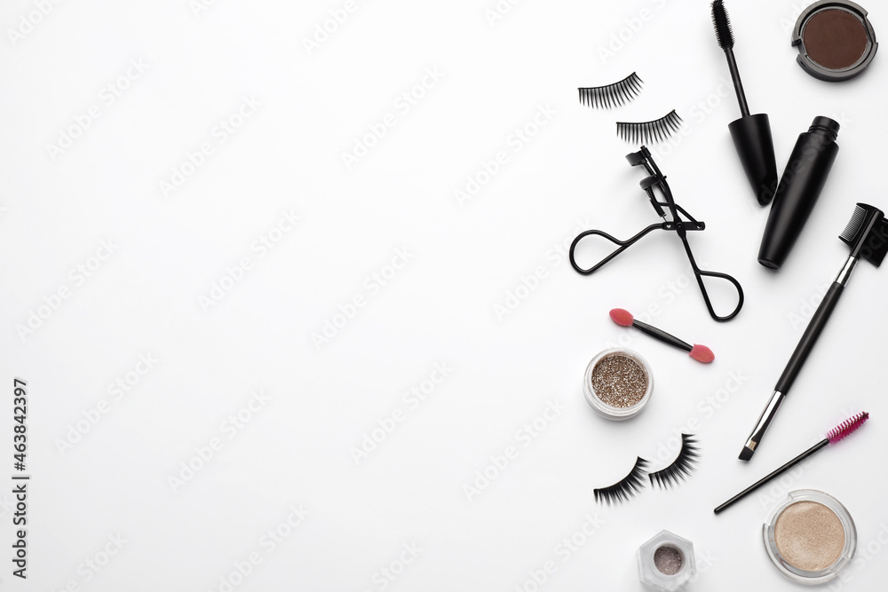 Composition with eyelash curler and makeup products on white background, top view Composition with eyelash curler and makeup products on white background, top view