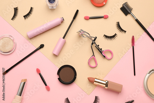 Flat lay composition with eyelash curler, makeup products and accessories on color background