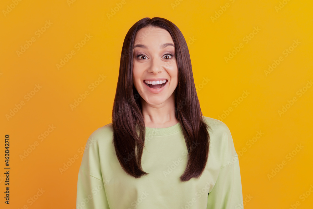 Fototapeta premium Photo of young excited girl amazed surprised omg wow news sale isolated over yellow color background
