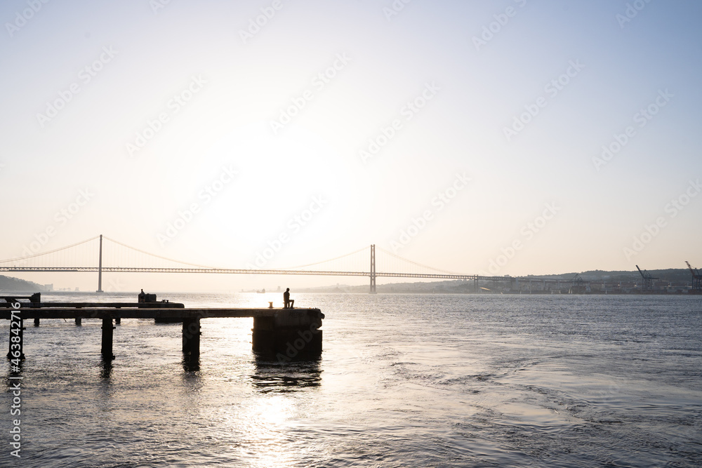 Photo with copy space of a man in front of the river of the image during sunset