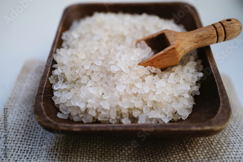 Coarse salt on the wooden bowl