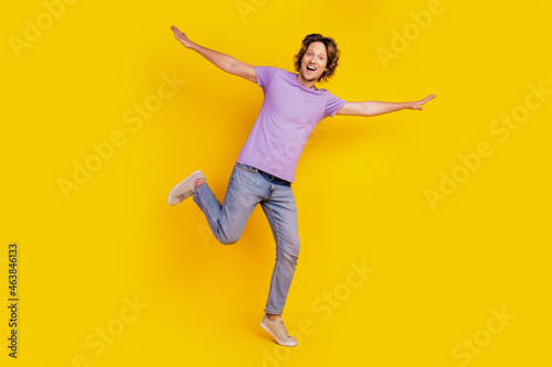 Excited funky cheerful man stand one leg fly plane enjoy flight carefree mood
