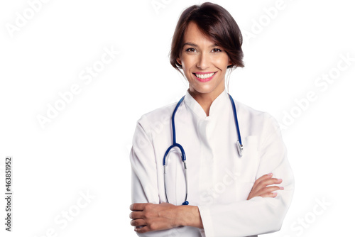 Attractive female doctor portrait while standing at isolated white background
