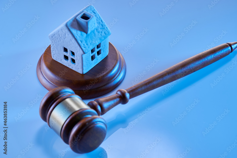 Obraz premium Gavel wooden and house for home buying or selling of bidding or lawyer of home real estate and building concept.