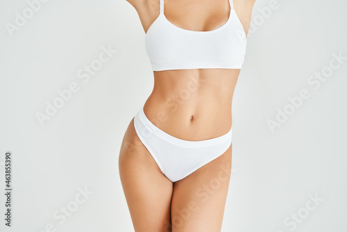 Perfect sporty body in white underwear of young woman