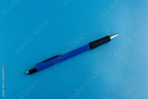 Top view blue pencil isolated on blue background.